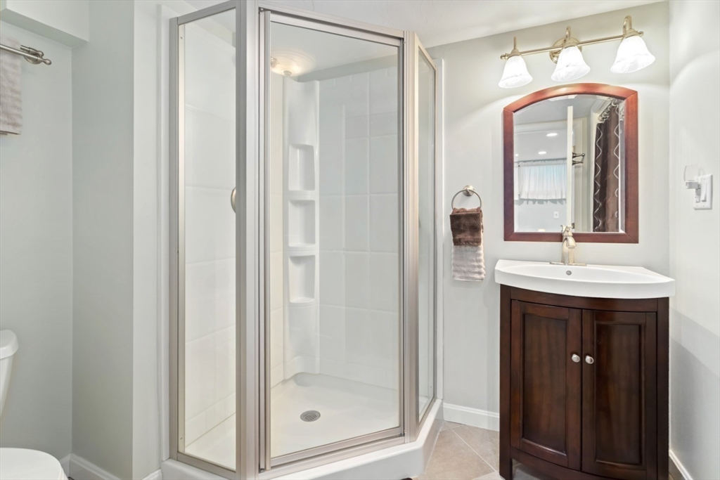 80 Squanto Road Quincy, MA 02169 - Photo 28 of 42 a bathroom with a sink a mirror and a shower