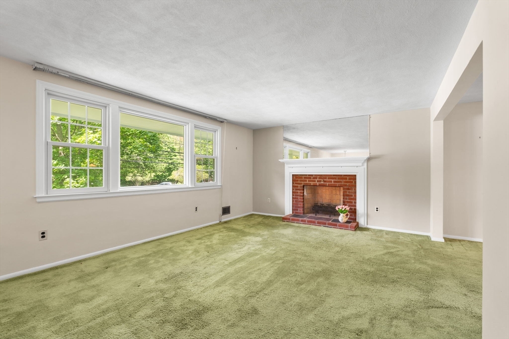 348 Belknap Road Framingham, MA 01701 - Photo 3 of 35 a view of an empty room with a window and a fireplace