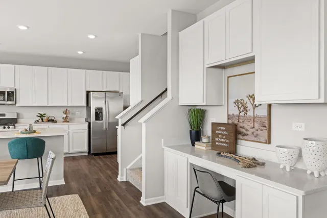 a kitchen with a sink cabinets and wooden floor
