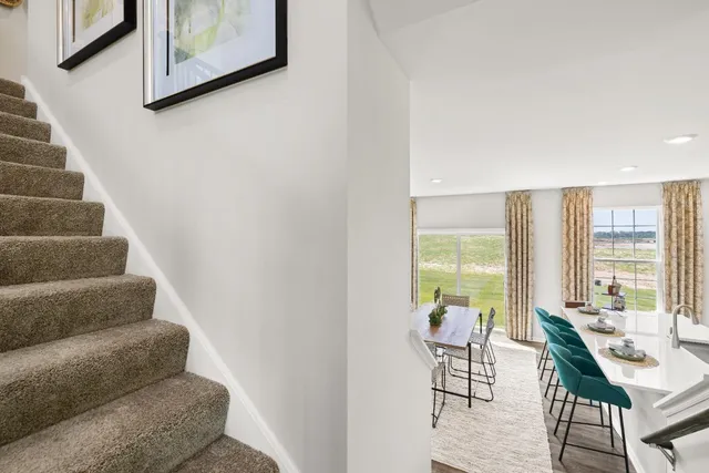 a view of a livingroom with furniture and floor to ceiling window