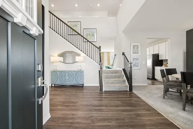 a view of entryway and hall with wooden floor