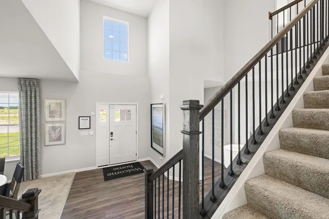 a view of a hallway with wooden floor and staircase