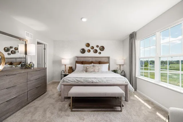 a spacious bedroom with a bed and a window