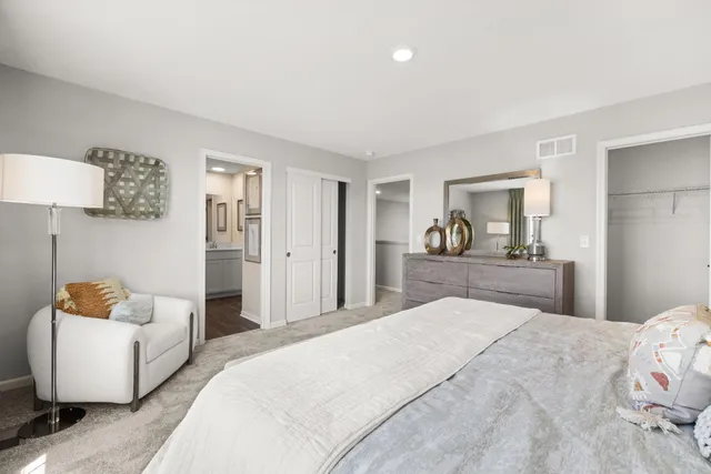 a bedroom with a bed and a couch