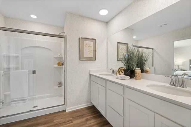 a bathroom with a shower sink and mirror