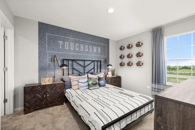 a bedroom with a large bed and a large window