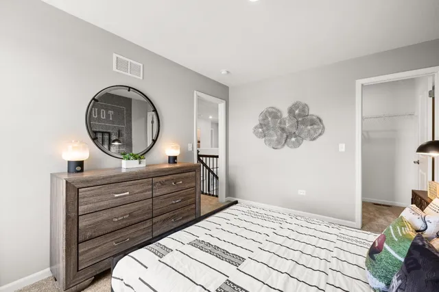 a bedroom with a bed and a dresser