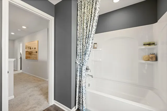 a bathroom with a bathtub and shower