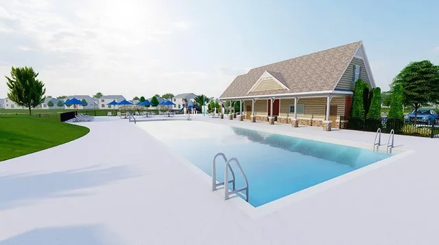 a view of a house with swimming pool and sitting area