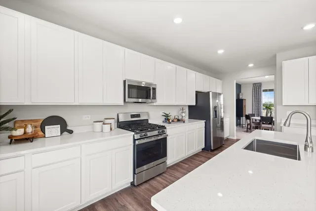 a kitchen with a sink a stove and cabinets