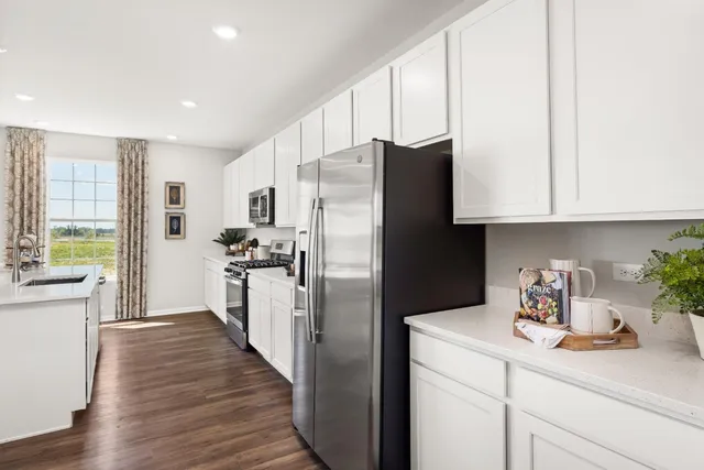 a kitchen with stainless steel appliances a refrigerator sink and cabinets