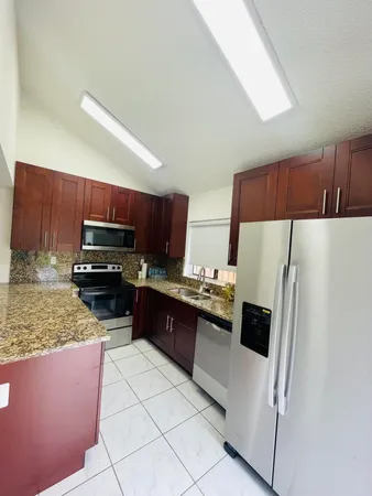 a kitchen with stainless steel appliances a refrigerator and a stove top oven