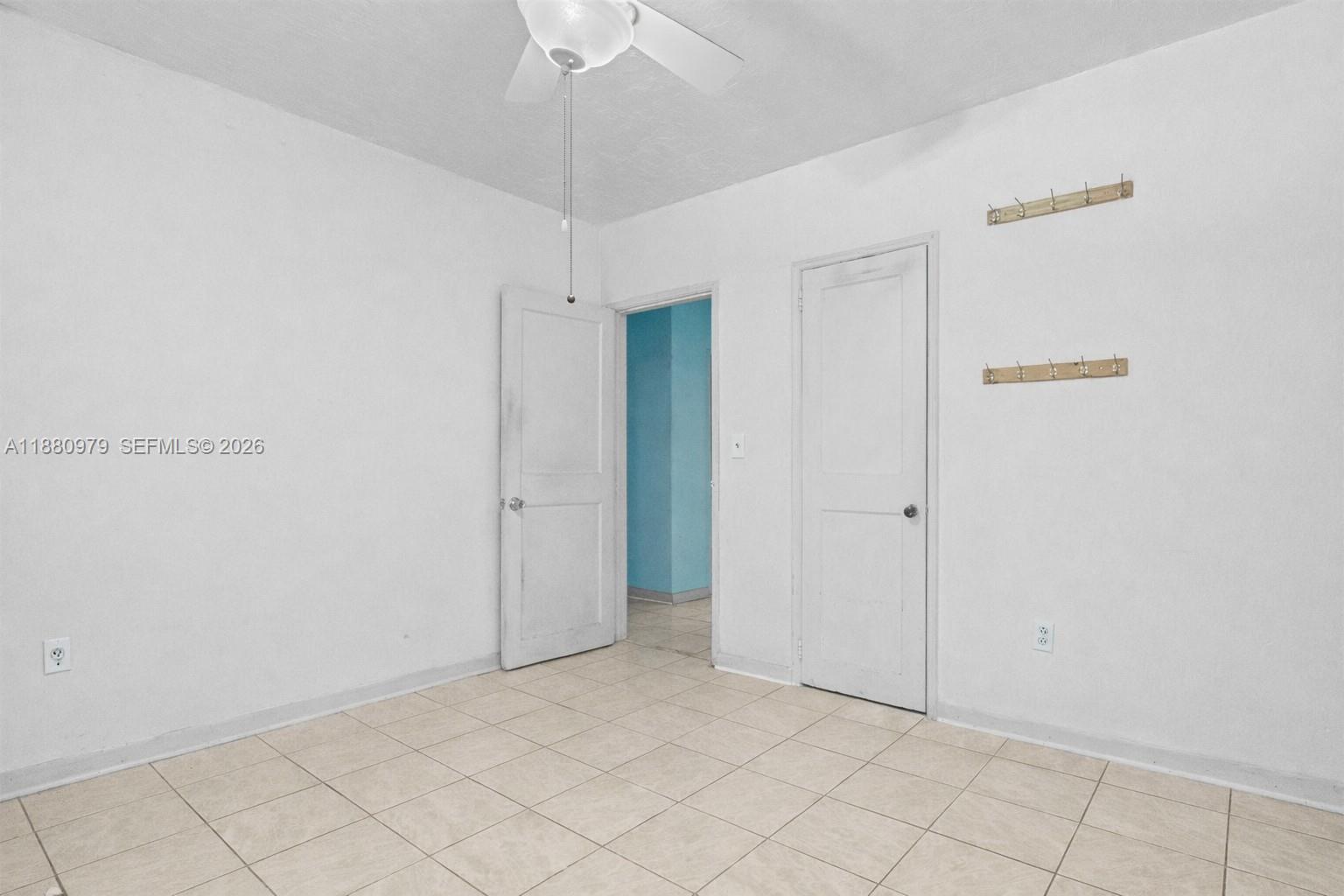 1345 Southwest 7th Street Miami, FL 33135 - Photo 17 of 37 an empty room with chandelier fan