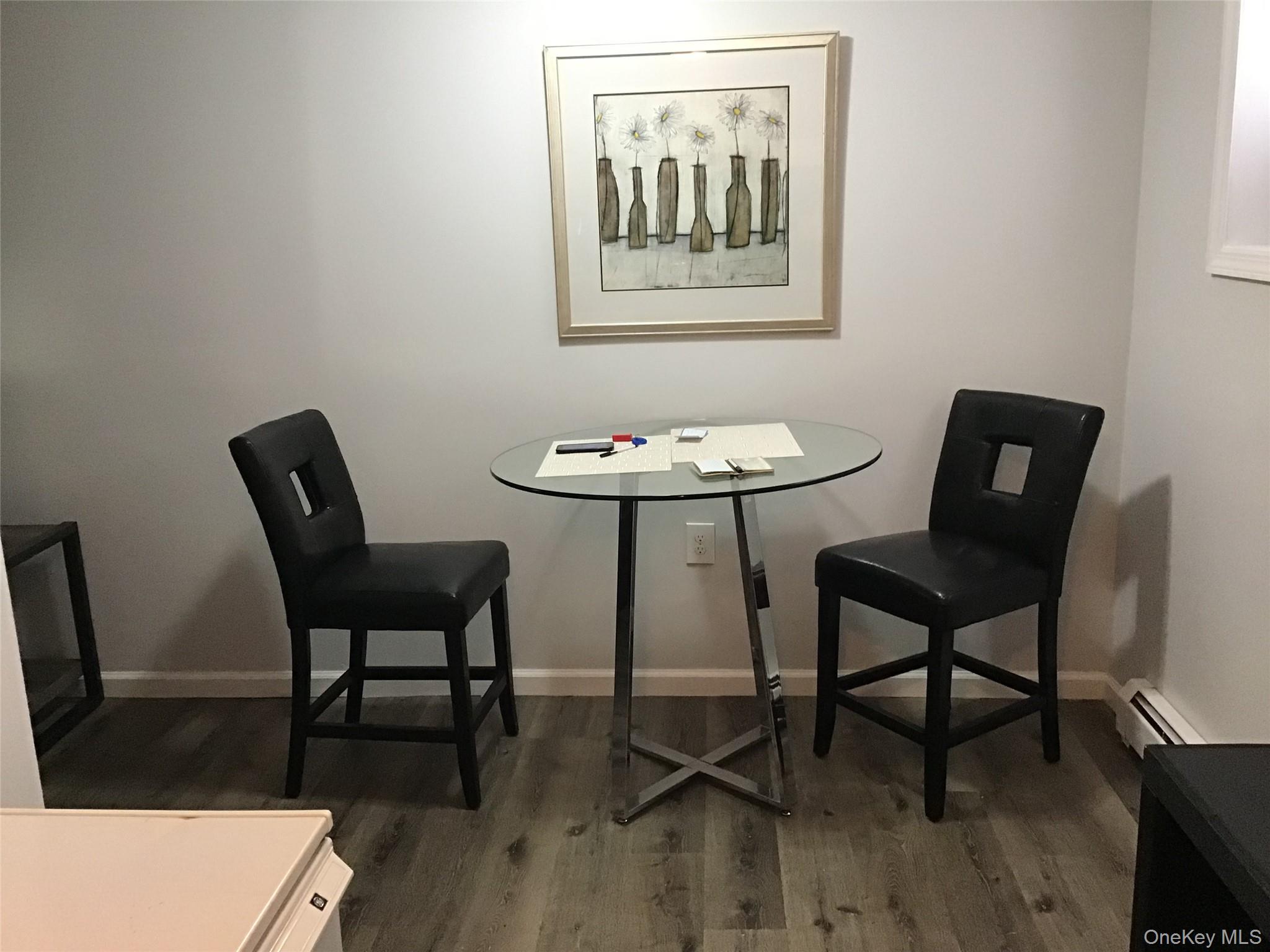 46 Benson Street West Haverstraw, NY 10993 - Photo 3 of 11 Dining area with baseboard heating and dark wood-type flooring