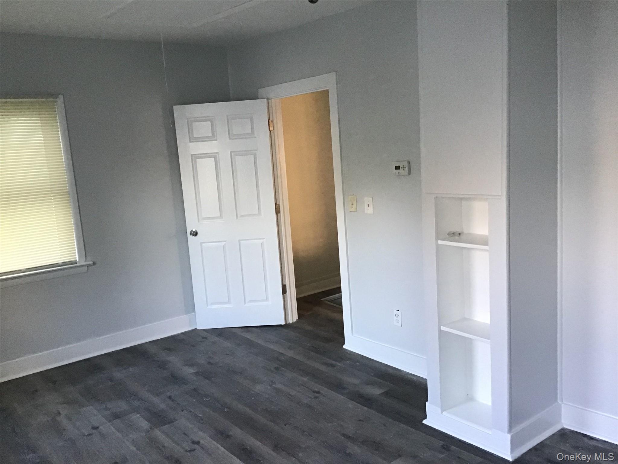 46 Benson Street West Haverstraw, NY 10993 - Photo 6 of 11 Unfurnished bedroom with dark wood-type flooring and baseboards