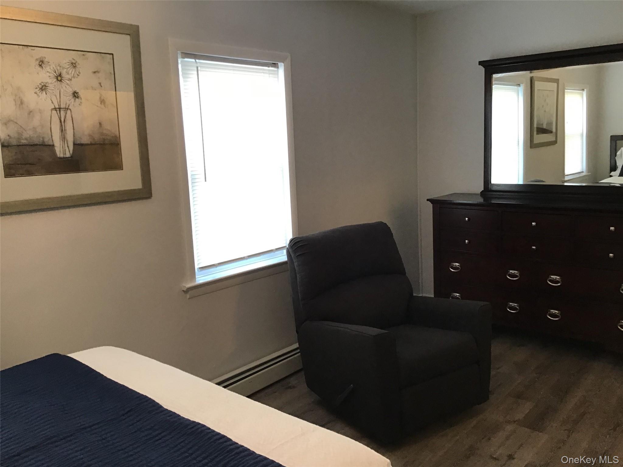 46 Benson Street West Haverstraw, NY 10993 - Photo 10 of 11 Bedroom featuring baseboard heating and dark wood finished floors