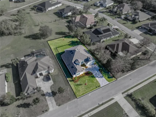 an aerial view of a house with a yard