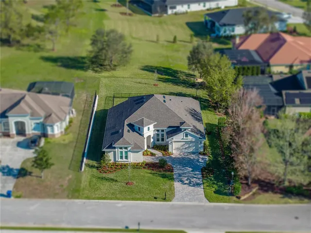 an aerial view of a house with a yard