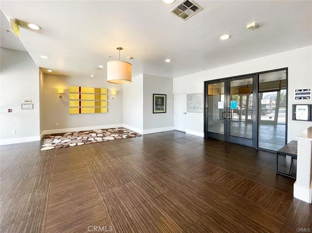 931 East Walnut Street, Unit 607 Pasadena, CA 91106 - Photo 21 of 30 an empty room with wooden floor and windows