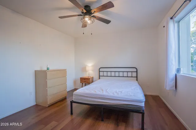 a bedroom with a bed and a dresser