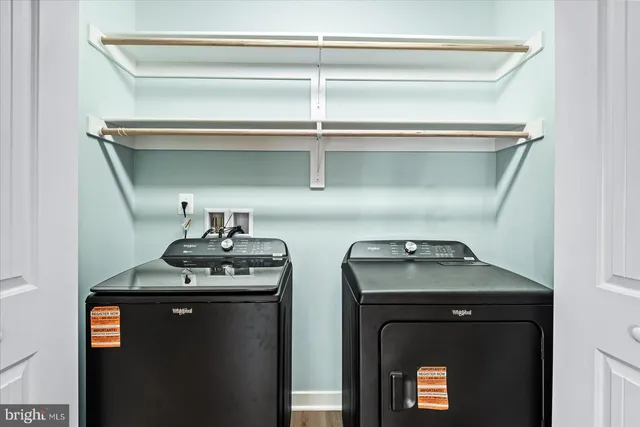 a utility room with two washing machine