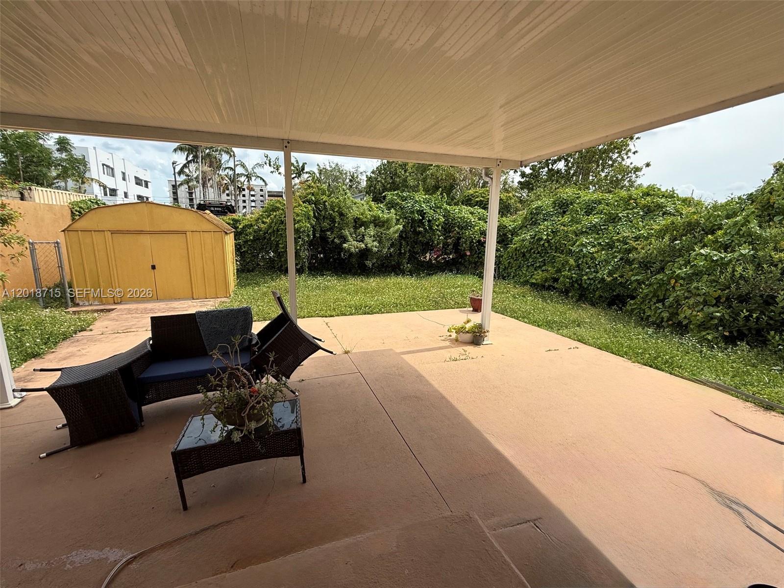 6720 Southwest 21st Street, Unit 1 Miami, FL 33155 - Photo 22 of 26 a view of backyard with swimming pool and outdoor seating