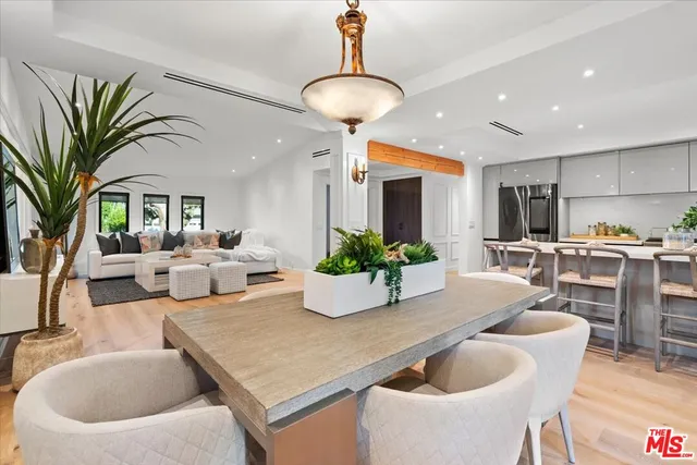 a living room with kitchen island furniture and a chandelier