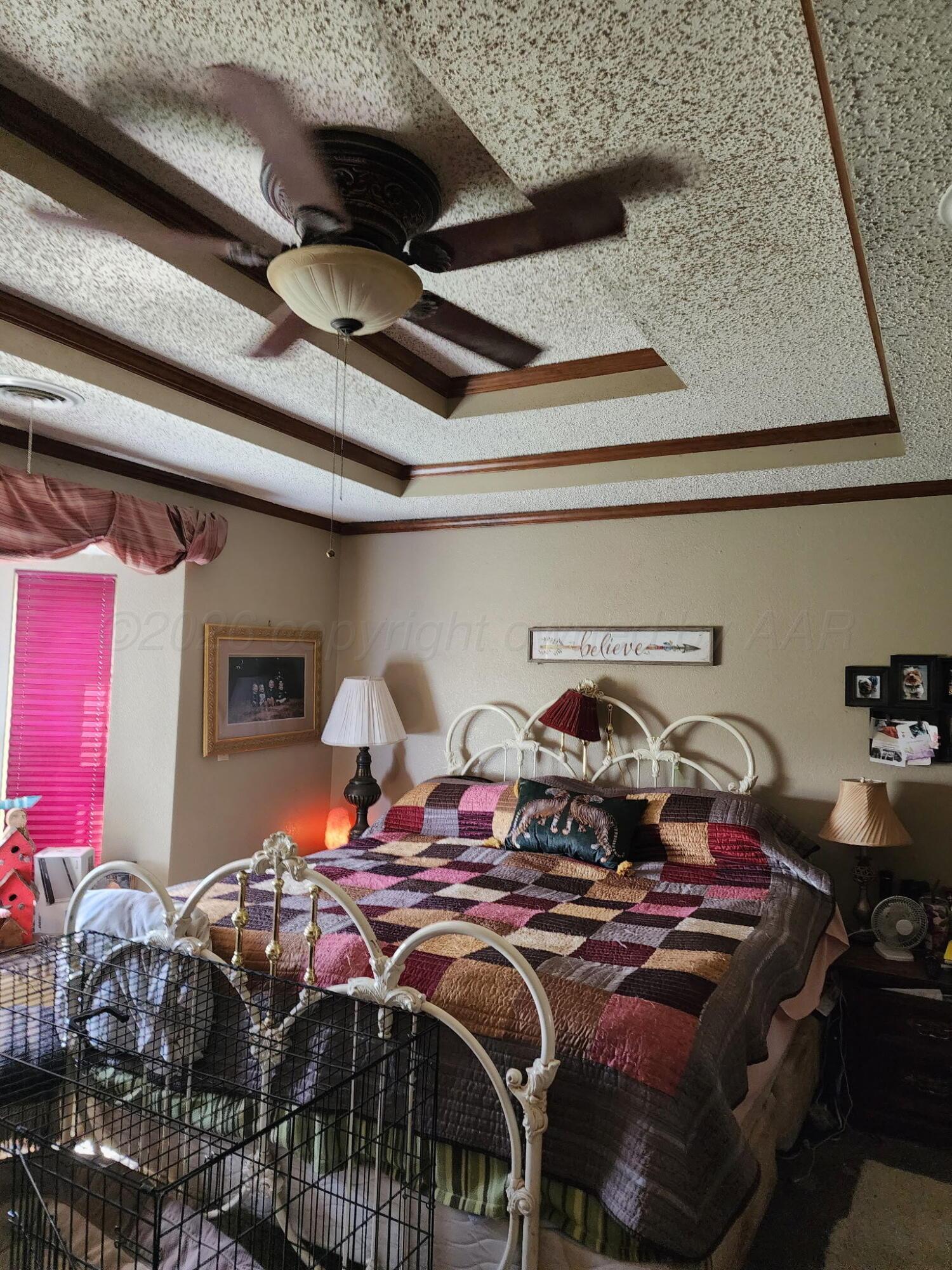 16700 Old Ranch Road Canyon, TX 79015 - Photo 23 of 54 a bed sitting in a bedroom next to a larger window