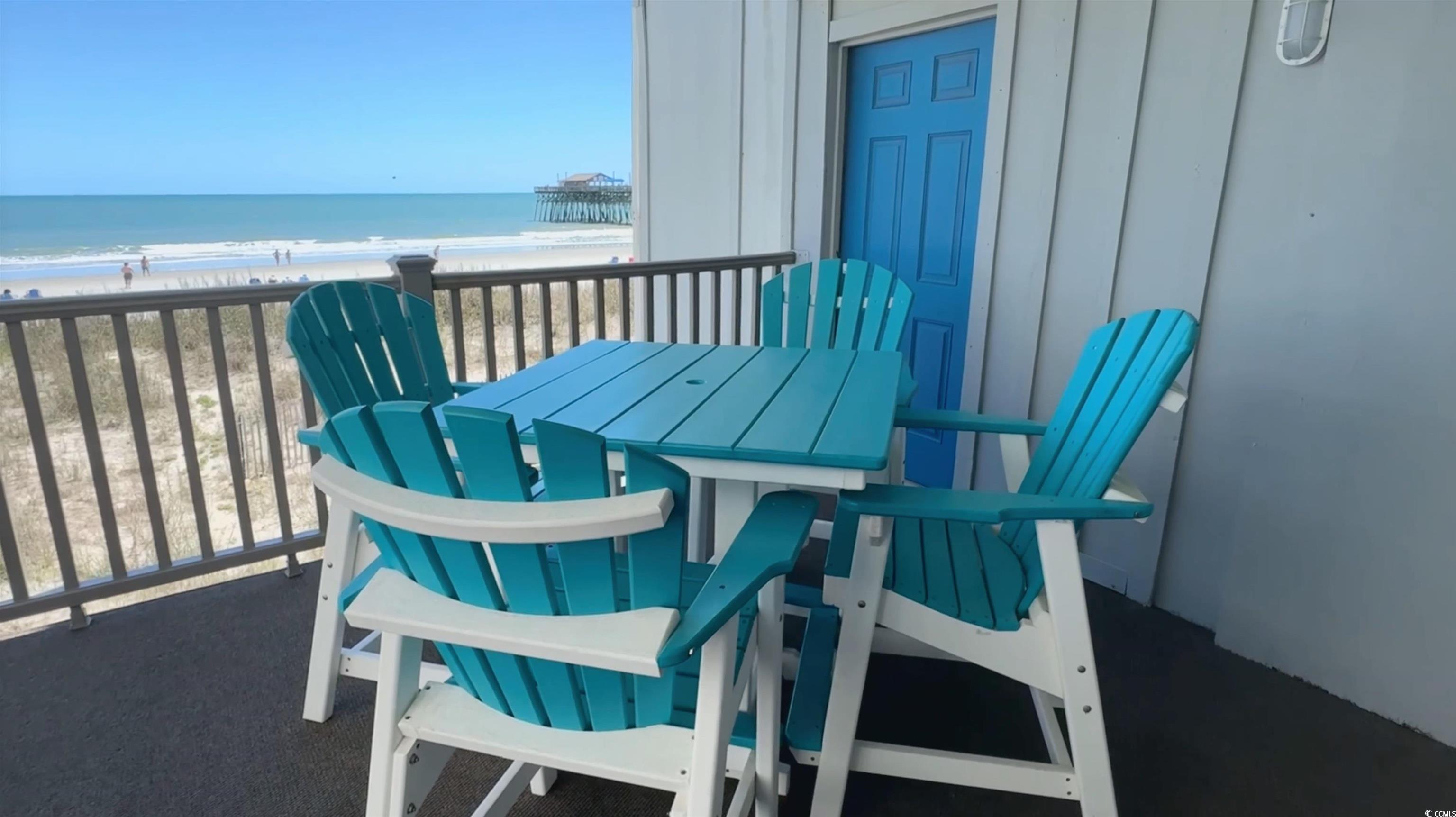 126 North Waccamaw Drive, Unit 101 Murrells Inlet, SC 29576 - Photo 14 of 28 Balcony featuring a beach view, a water view, and outdoor dining space