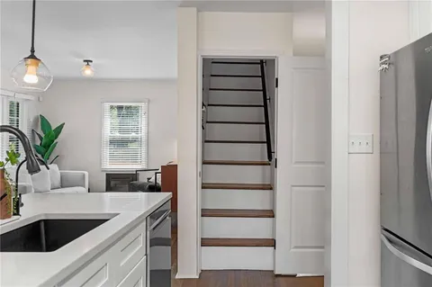 a kitchen with a refrigerator and a sink
