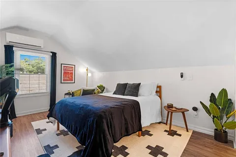 a bedroom with a bed and a potted plant