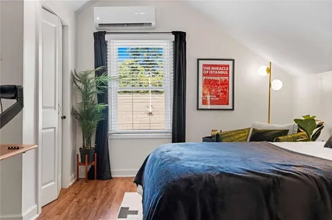 a bedroom with a bed and a potted plant