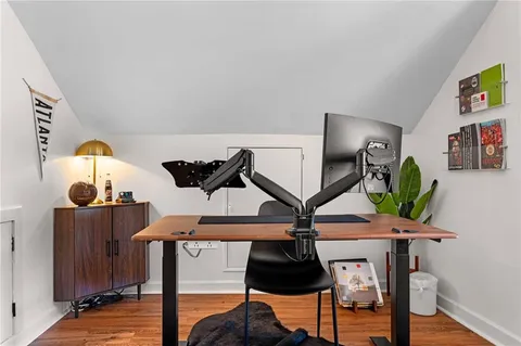 a view of entryway and hall with wooden floor
