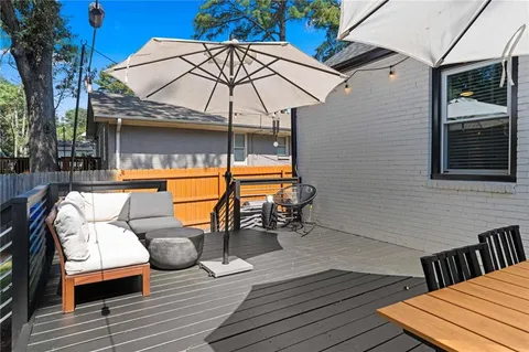 a view of balcony with wooden floor and umbrella