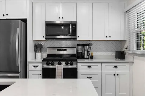 a kitchen with appliances a cabinets and a counter space