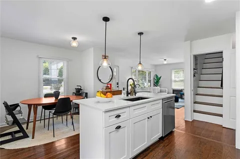 a view of a kitchen area with furniture and wooden floor
