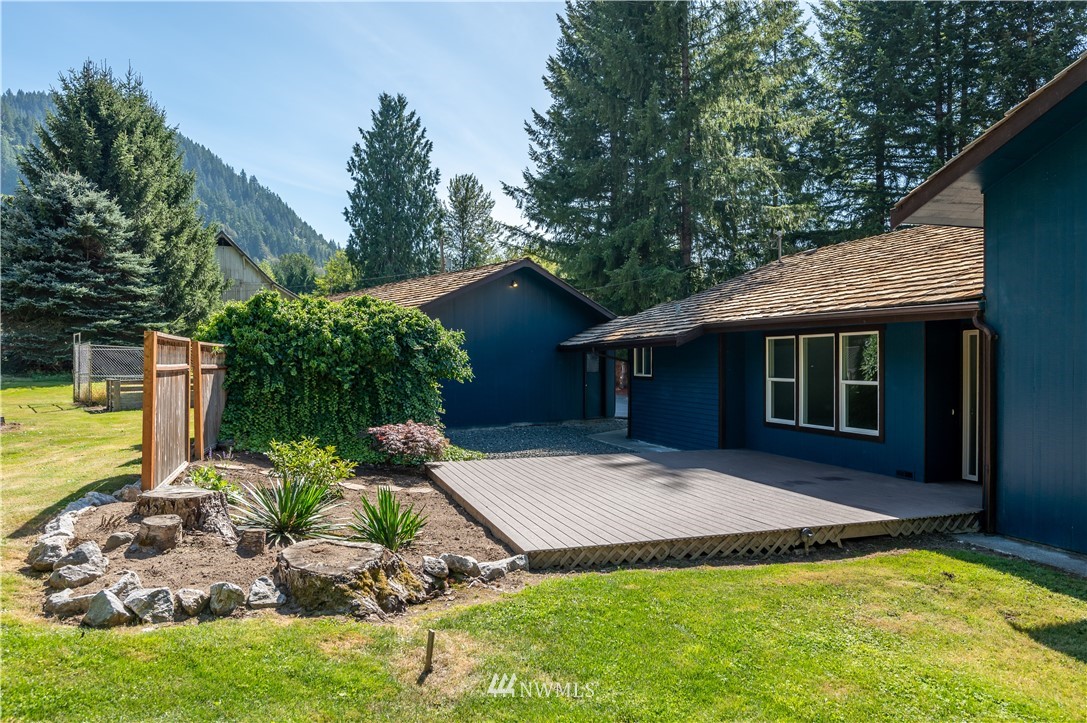 4086 Linnell Road Deming, WA 98244 - Photo 13 of 38 a view of a house with a yard potted plants and large tree