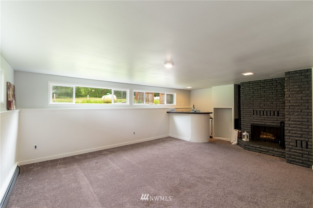 4086 Linnell Road Deming, WA 98244 - Photo 26 of 38 a view of an empty room with a fireplace and a window