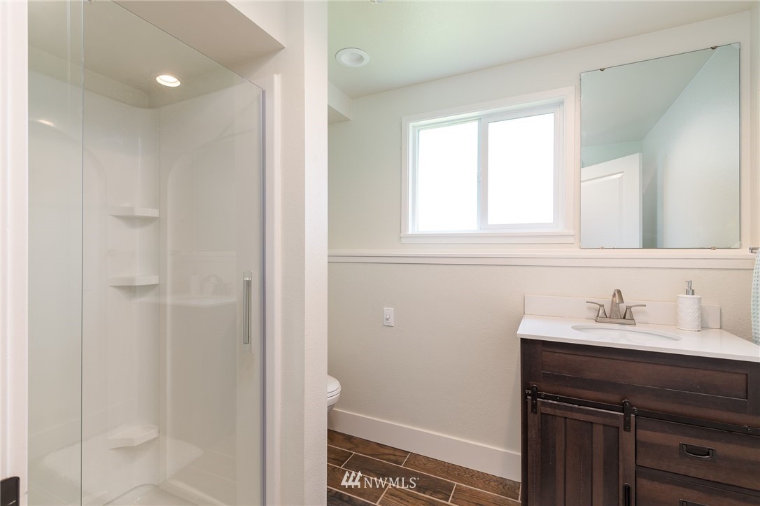 4086 Linnell Road Deming, WA 98244 - Photo 27 of 38 a bathroom with a sink a vanity and a mirror