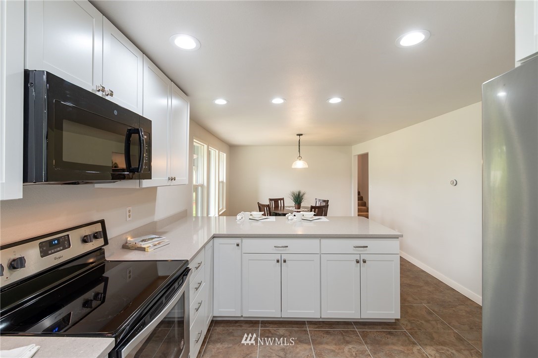 4086 Linnell Road Deming, WA 98244 - Photo 4 of 38 a kitchen with a sink stainless steel appliances and cabinets