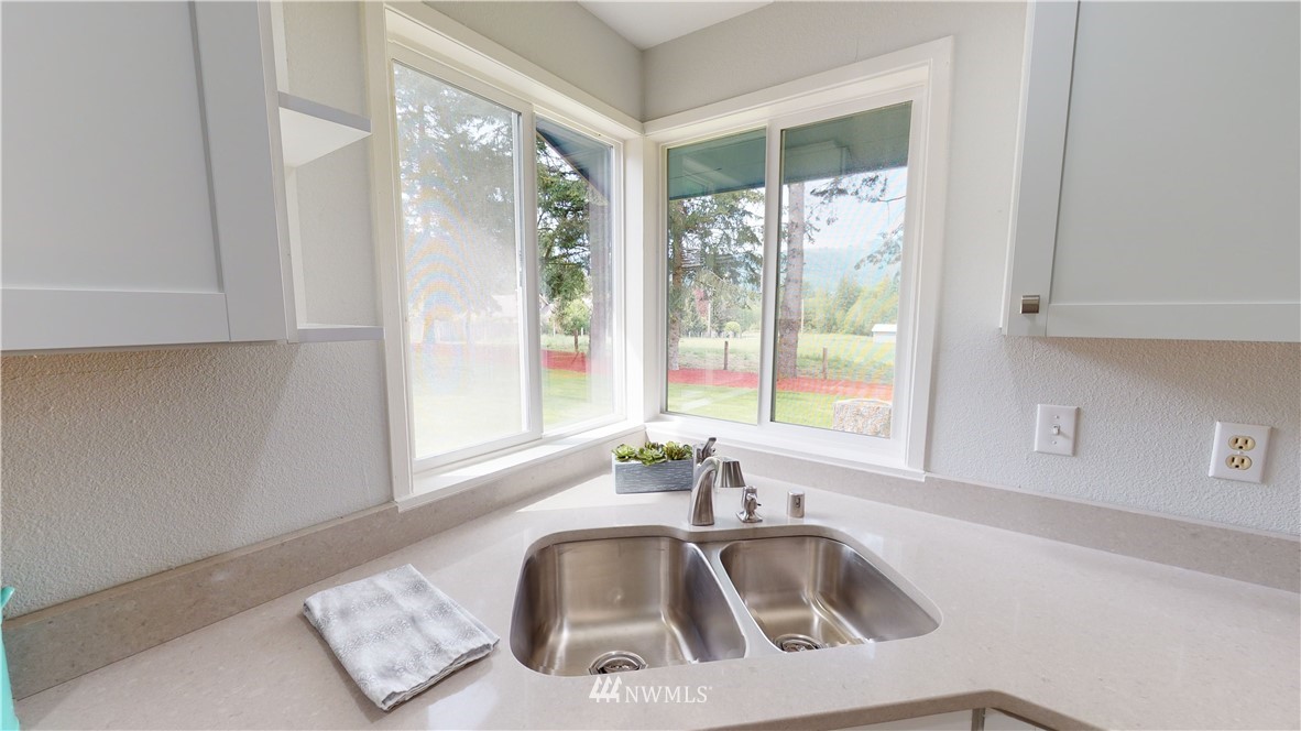 4086 Linnell Road Deming, WA 98244 - Photo 5 of 38 a kitchen with granite countertop a sink and a window