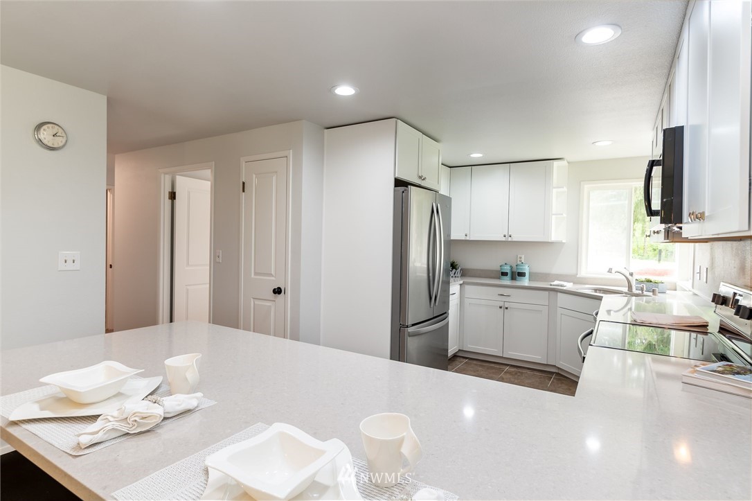 4086 Linnell Road Deming, WA 98244 - Photo 6 of 38 a kitchen with refrigerator and cabinets