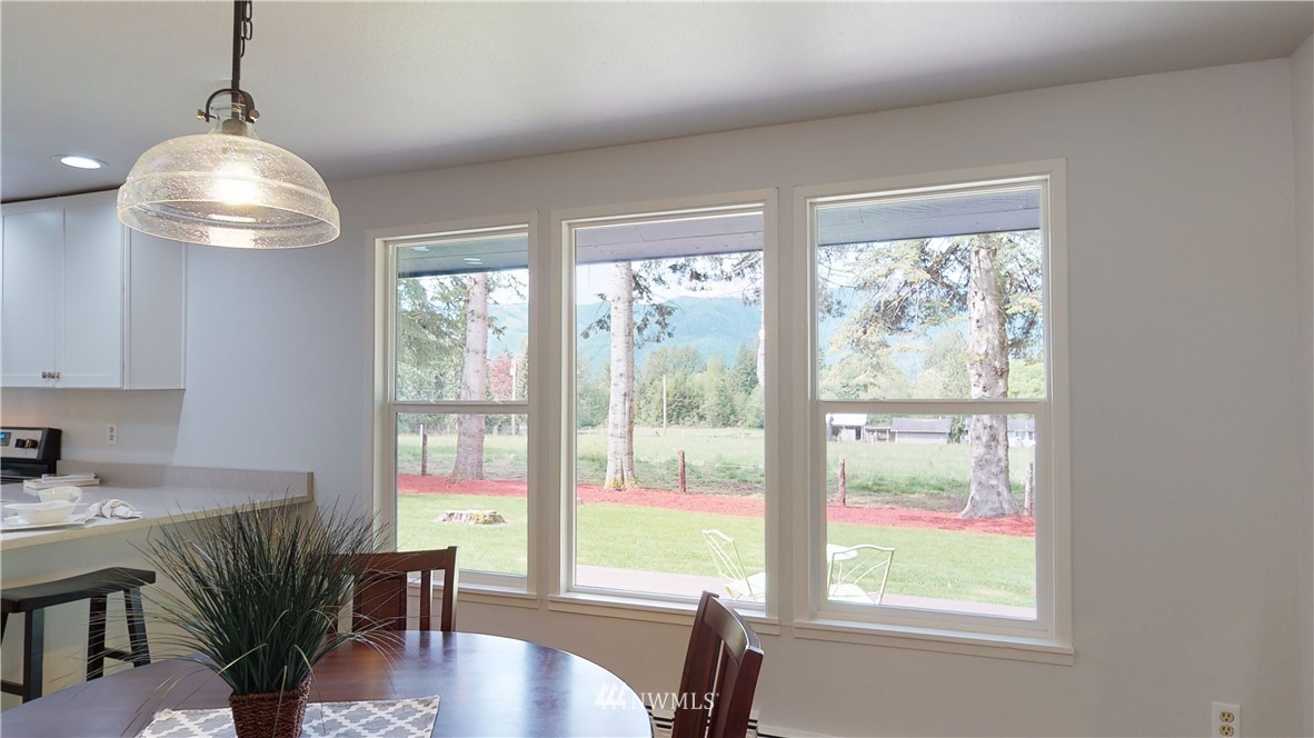 4086 Linnell Road Deming, WA 98244 - Photo 8 of 38 a view of a dining room with furniture window and outside view