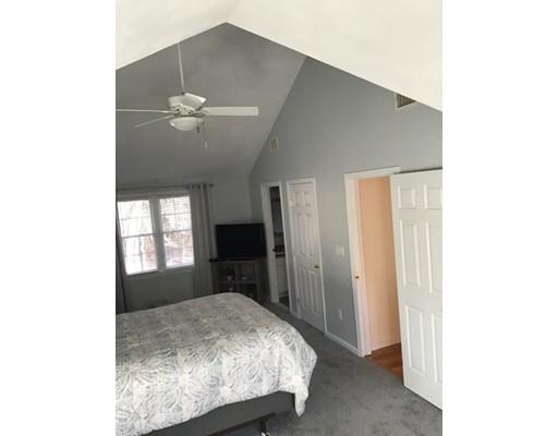 45 Chatham Road Billerica, MA 01821 - Photo 15 of 29 a bedroom with a bed and a chandelier