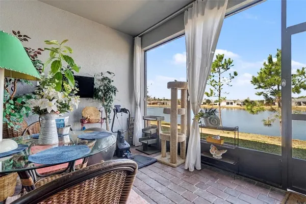 a balcony with furniture and a potted plant