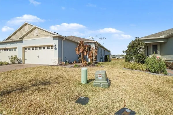 a view of a house with backyard and trees