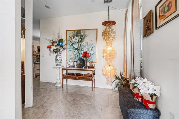 a living room with furniture and flowers