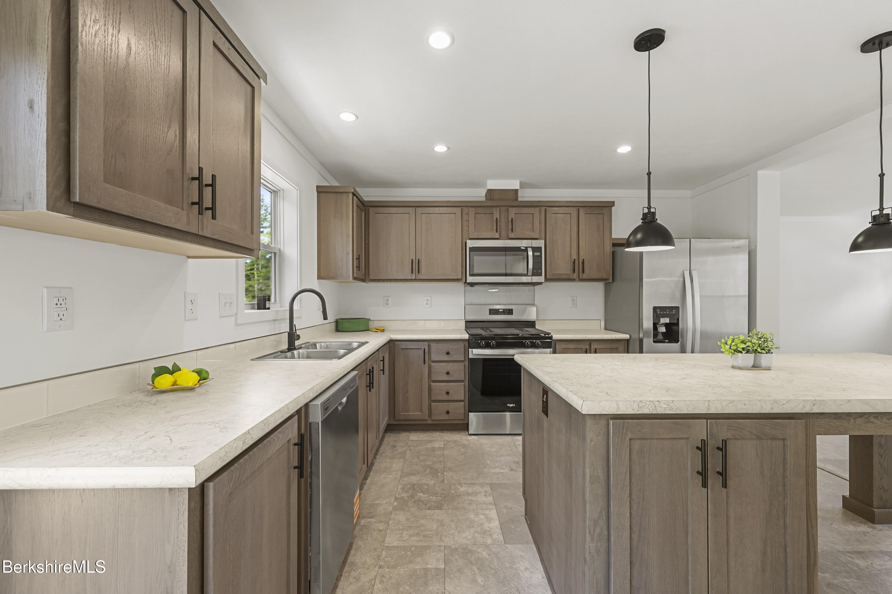 395 Cheshire Road, Unit 112 Pittsfield, MA 01201 - Photo 11 of 32 a kitchen with a sink a counter top space appliances and cabinets