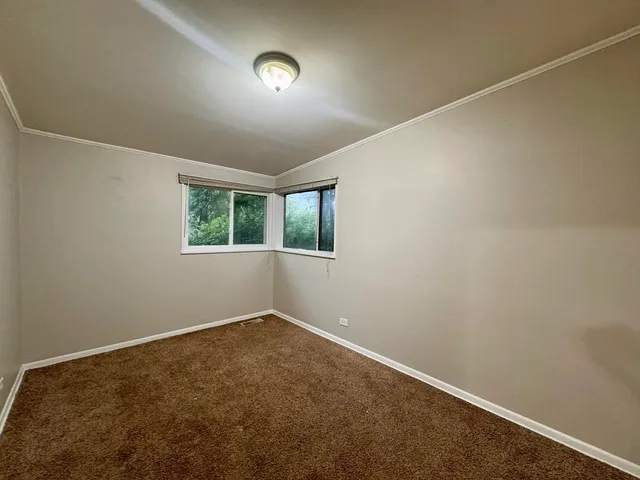 an empty room with a empty space and windows