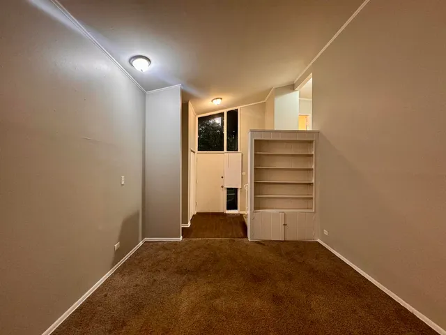 a view of an empty room with a closet
